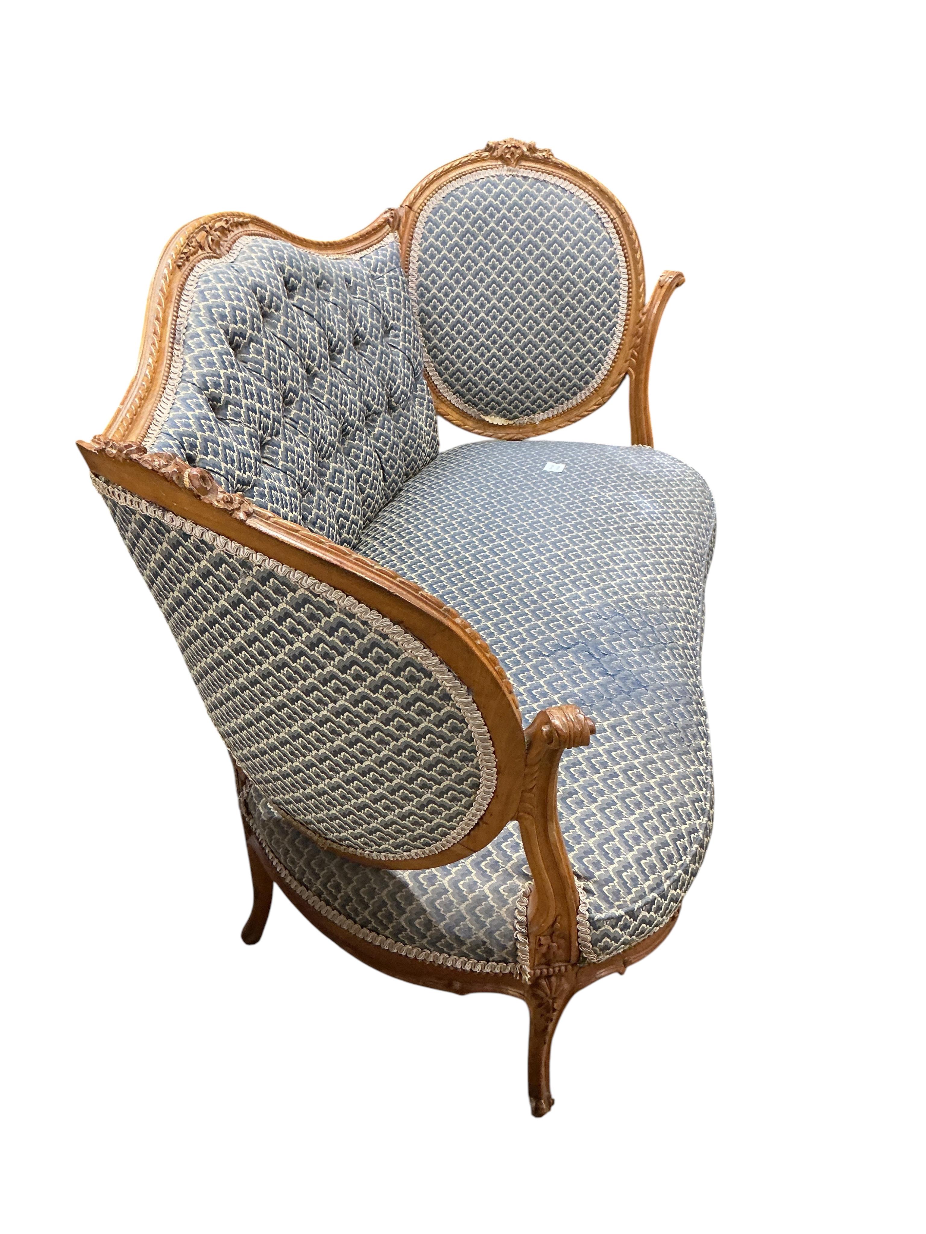 A late 19th / early 20th century French upholstered carved walnut upholstered settee, width 136cm, depth 68cm, height 86cm